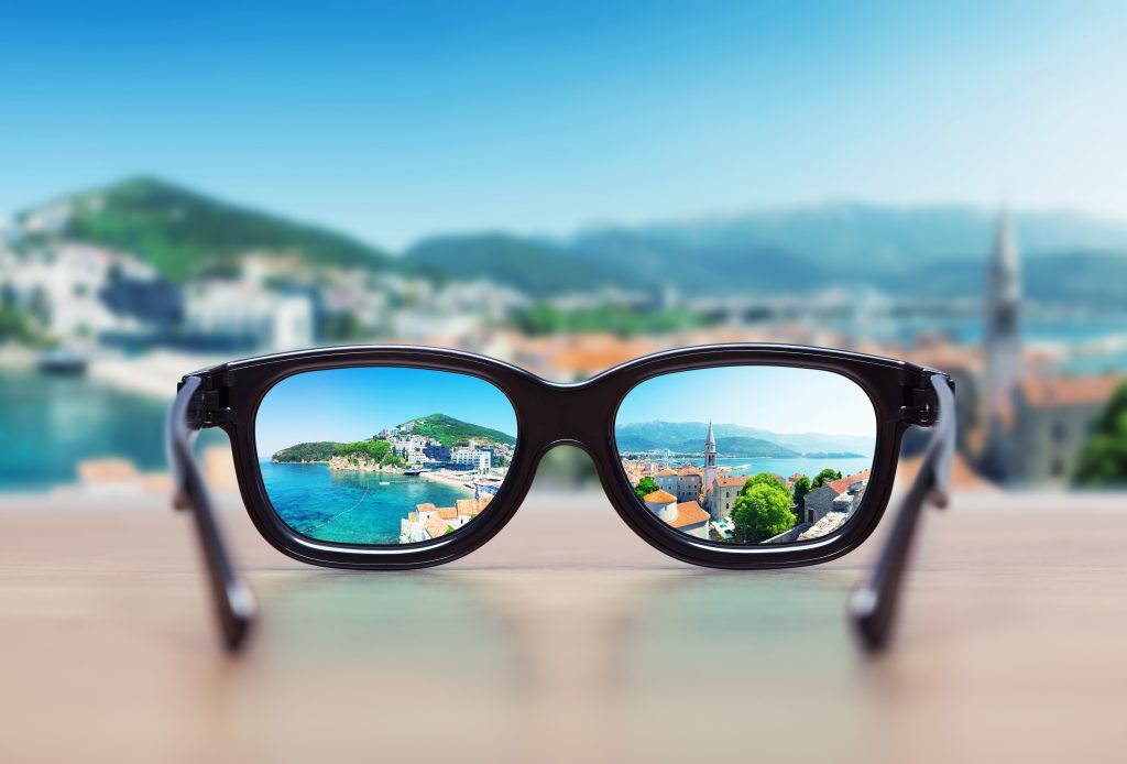 Cityscape focused in glasses lenses Cityscape focused in glasses lenses. Vision concept
